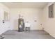 Epoxy-floored garage with a utility sink and water heater, offering a practical space for projects at 1357 Nimrod St, Port Charlotte, FL 33952