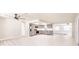 Open-concept kitchen with stainless steel appliances, modern grey cabinets, and bright, airy atmosphere at 1357 Nimrod St, Port Charlotte, FL 33952