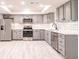 Updated kitchen featuring stainless steel appliances, gray cabinets, and subway tile backsplash at 1357 Nimrod St, Port Charlotte, FL 33952
