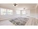 Living room with wood flooring, paneled walls, and large windows offering plenty of light at 1357 Nimrod St, Port Charlotte, FL 33952