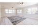 Living room with wood flooring, paneled walls, and large windows offering plenty of light at 1357 Nimrod St, Port Charlotte, FL 33952