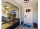 Cozy front porch featuring tiled flooring, a charming welcome mat, and decorative plants enhancing curb appeal at 1357 Nimrod St, Port Charlotte, FL 33952