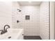 Walk-in shower featuring subway tile and modern fixtures, paired with a sleek vanity at 1357 Nimrod St, Port Charlotte, FL 33952