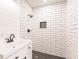 Shower featuring white subway tile, black fixtures, and a modern vanity at 1357 Nimrod St, Port Charlotte, FL 33952