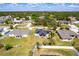 Aerial view of a home with solar panels, showcasing the surrounding neighborhood and green landscape at 1721 Nicollett Ave, North Port, FL 34286