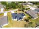 Aerial view of a home with solar panels, showcasing the surrounding neighborhood and green landscape at 1721 Nicollett Ave, North Port, FL 34286
