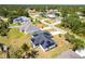 Aerial view of a home with solar panels, showcasing the surrounding neighborhood and green landscape at 1721 Nicollett Ave, North Port, FL 34286