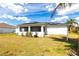 The home's exterior features a screen porch, solar panels and a spacious lawn at 1721 Nicollett Ave, North Port, FL 34286