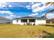 The home's exterior features a screen porch, solar panels and a spacious lawn at 1721 Nicollett Ave, North Port, FL 34286