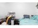 Bedroom with a turquoise bed, study desk, and office chair in a bright, simple space at 1721 Nicollett Ave, North Port, FL 34286