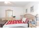 Bright bedroom with light walls features dresser with a vanity mirror and side tables at 1721 Nicollett Ave, North Port, FL 34286