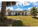 Single-story home with solar panels, featuring a well-maintained yard and a functional two-car garage at 1721 Nicollett Ave, North Port, FL 34286