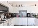 Bright kitchen features white cabinetry, modern appliances, and decorative backsplash at 1721 Nicollett Ave, North Port, FL 34286