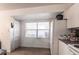 Efficient kitchen features an abundance of natural light, white cabinetry, and essential appliances at 1721 Nicollett Ave, North Port, FL 34286