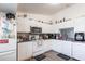 Bright kitchen features white cabinets, stainless steel appliances and eat-in breakfast counter seating at 1721 Nicollett Ave, North Port, FL 34286