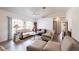 Comfortable living room features wood flooring, bright light from the large windows, and vaulted ceilings at 1721 Nicollett Ave, North Port, FL 34286
