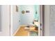 Charming powder room with nautical decor and wood-look flooring at 17420 Jadestone Ct, Venice, FL 34293