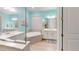 Bright bathroom featuring dual sinks, soaking tub, and stylish finishes at 17420 Jadestone Ct, Venice, FL 34293