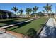 Bocce court featuring multiple play areas, bordered by pavers and tropical landscaping at 17420 Jadestone Ct, Venice, FL 34293