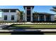 Exterior of the clubhouse with manicured landscaping and a nearby bocce ball court at 17420 Jadestone Ct, Venice, FL 34293