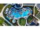 Aerial view of a luxury resort-style pool featuring ample seating, shaded areas, and lush landscaping for ultimate relaxation at 17420 Jadestone Ct, Venice, FL 34293