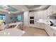 Bright open kitchen featuring stainless steel appliances, white cabinets, and a large island at 17420 Jadestone Ct, Venice, FL 34293