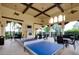 Inviting community recreation room with a ping pong table, comfortable seating, and elegant ceiling fans for leisure activities at 17420 Jadestone Ct, Venice, FL 34293