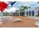Exterior view of a modern restaurant with outdoor seating, stylish awnings, and a welcoming ambiance for social gatherings at 17420 Jadestone Ct, Venice, FL 34293