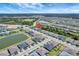 Aerial view of a neighborhood with houses, palm trees, green spaces, waterways, and community areas at 1796 W Palms Dr, Port Charlotte, FL 33953