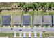 Aerial view of homes in a new development showing roof lines, driveways, and street with parked cars at 1796 W Palms Dr, Port Charlotte, FL 33953