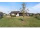 Well-manicured back yard with healthy grass, a screen porch, and a fenced perimeter at 1796 W Palms Dr, Port Charlotte, FL 33953