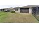 Exterior of home featuring screened in porch and fenced in yard at 1796 W Palms Dr, Port Charlotte, FL 33953