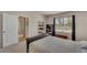 Bedroom with adjacent closet, hardwood floors in the hallway, and large window with blinds at 1796 W Palms Dr, Port Charlotte, FL 33953