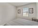 This is a simply decorated bedroom with a window and carpet at 1796 W Palms Dr, Port Charlotte, FL 33953