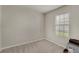 This cozy bedroom has carpeted floors and a bright window at 1796 W Palms Dr, Port Charlotte, FL 33953