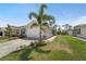 Lovely one-story home with a two-car garage, manicured landscaping, and a brick-paved driveway at 1796 W Palms Dr, Port Charlotte, FL 33953