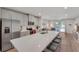 Bright, open kitchen with stainless steel appliances, grey cabinetry, and a large island with seating at 1796 W Palms Dr, Port Charlotte, FL 33953