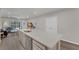 Spacious kitchen with large island connecting to the living room, featuring modern appliances at 1796 W Palms Dr, Port Charlotte, FL 33953