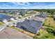 Street view of a neighborhood with houses, palm trees, green spaces, and blue skies in a planned community at 1796 W Palms Dr, Port Charlotte, FL 33953