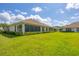 Expansive backyard with lush green lawn and manicured landscaping at 1940 Scarlett Ave, North Port, FL 34289