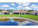 Scenic backyard view featuring a pond, lush green grass, and a serene landscape at 1940 Scarlett Ave, North Port, FL 34289