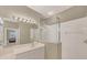 Well-lit bathroom featuring a glass-enclosed shower and view to the bedroom at 1940 Scarlett Ave, North Port, FL 34289
