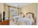 Bright bedroom with twin beds, ceiling fan, and large window with lots of light at 1940 Scarlett Ave, North Port, FL 34289