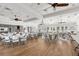 Spacious community room with wood floors, chandeliers, and plenty of seating at 1940 Scarlett Ave, North Port, FL 34289