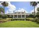 A beautiful clubhouse features manicured landscaping and classic architectural details at 1940 Scarlett Ave, North Port, FL 34289