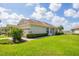 Beautiful single-story home with a well-manicured lawn, and a paved driveway at 1940 Scarlett Ave, North Port, FL 34289