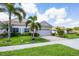 Charming single-story home featuring a paved driveway, lush landscaping, and an attached two-car garage at 1940 Scarlett Ave, North Port, FL 34289