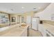 Bright kitchen features white cabinetry, modern appliances, and a breakfast bar at 1940 Scarlett Ave, North Port, FL 34289