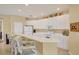 Bright kitchen features white cabinetry, a breakfast bar with seating, and modern appliances at 1940 Scarlett Ave, North Port, FL 34289