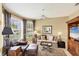 Comfortable living room with a bay window, ceiling fan, and leather furniture at 1940 Scarlett Ave, North Port, FL 34289